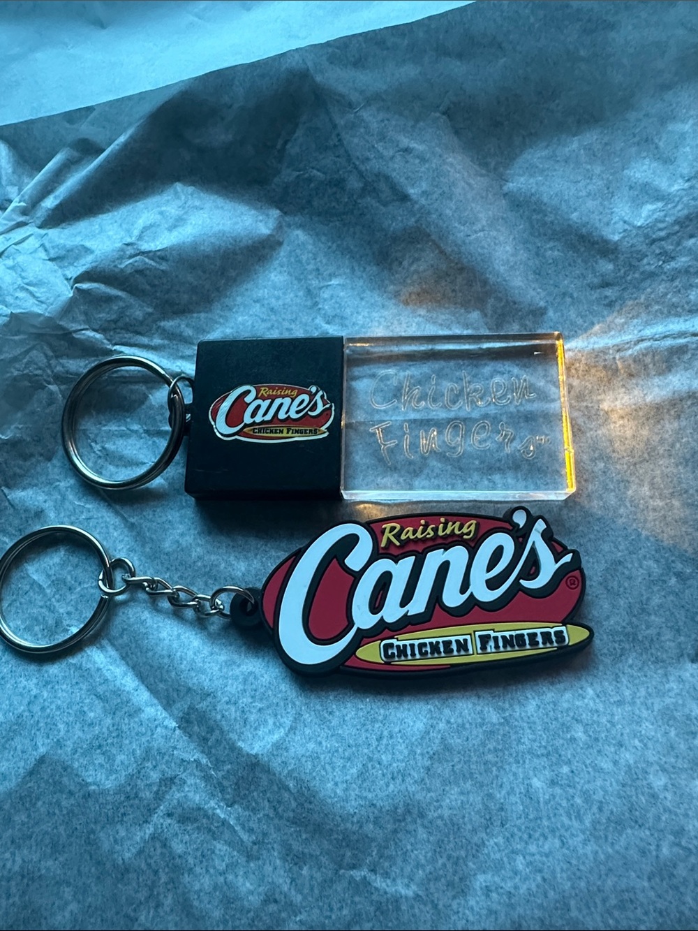 official Raising Cane's iconic logo,and iconic chicken finger sign keychains